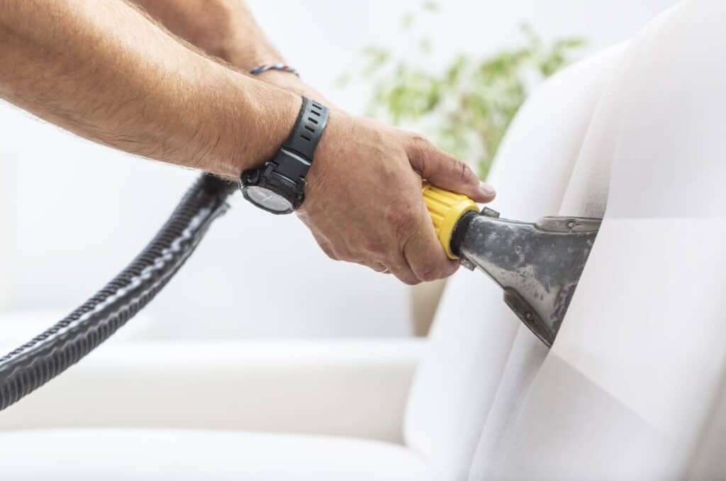 a person using a vacuum cleaner