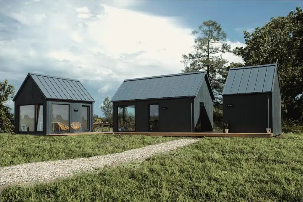a group of small houses in a grassy area