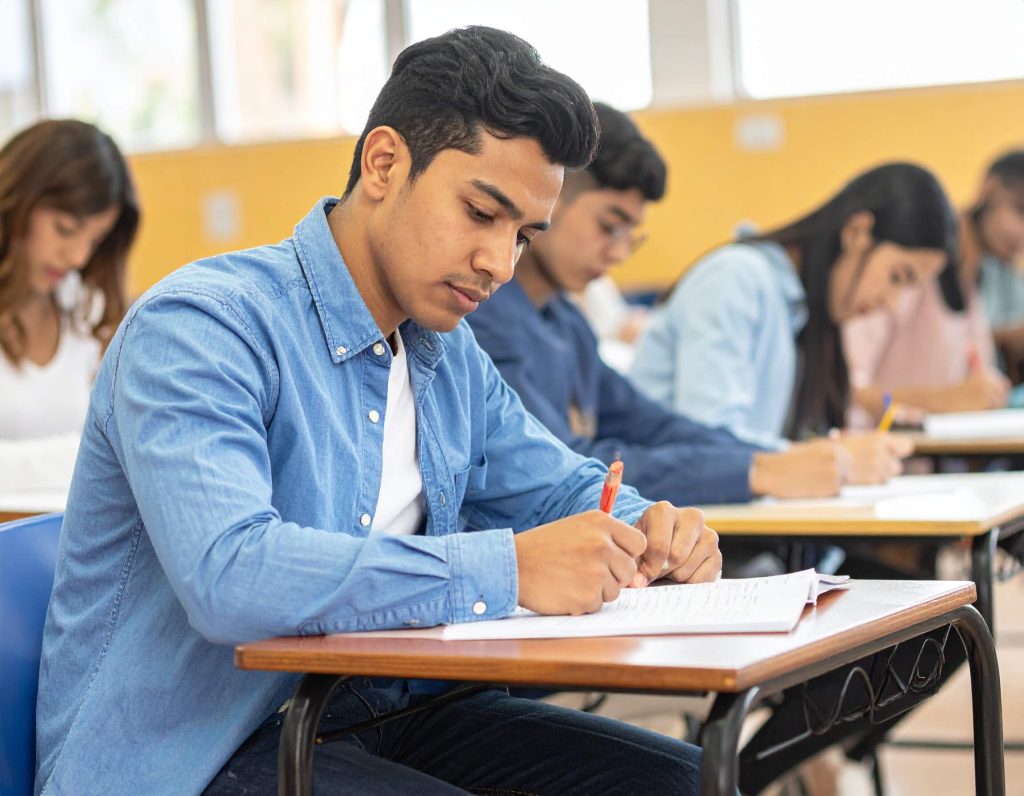 Students focused on exam in classroom.